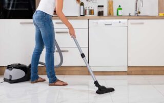 Summary: A woman vacuuming a kitchen tile floor demonstrates the best way to clean tile floors and maintain their shine and cleanliness. Learn essential techniques and tips to keep your tile floors spotless, preserving their appearance and durability for the long term.