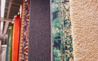 Various colorful carpet tiles displayed in a row for installation, comparing Carpet Tiles vs Traditional Carpeting in terms of flexibility and style.
