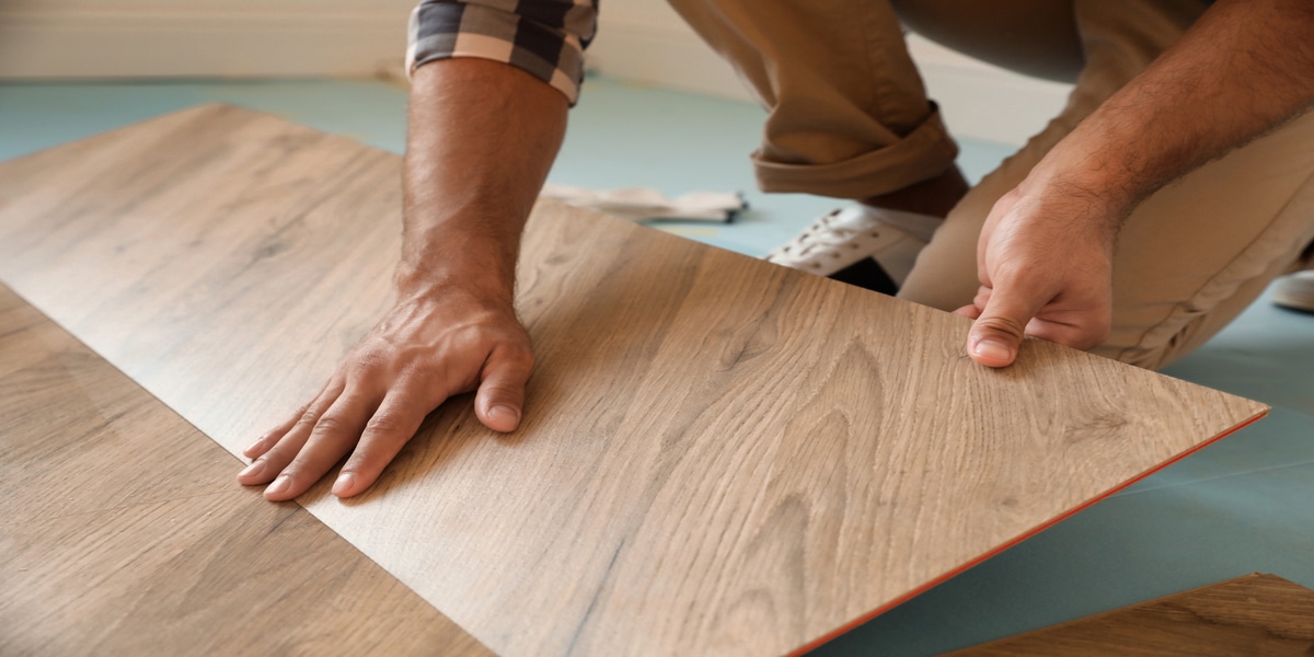 Person installing laminate wood flooring