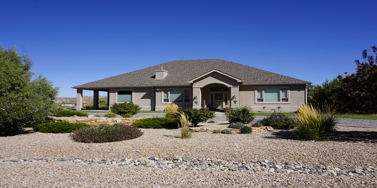 How Colorado’s Dry Climate Is Rewriting Manufacturer Installation Specs Desert-style house with landscaped front yard
