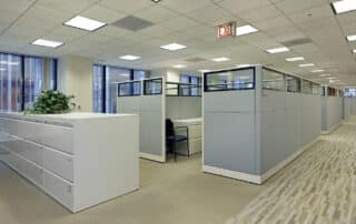 Modern office hallway with cubicles and filing cabinets