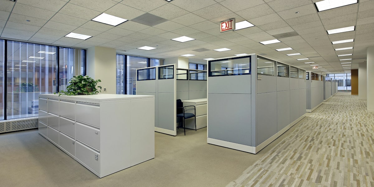 How to Save Money on Commercial Carpets Modern office hallway with cubicles and filing cabinets