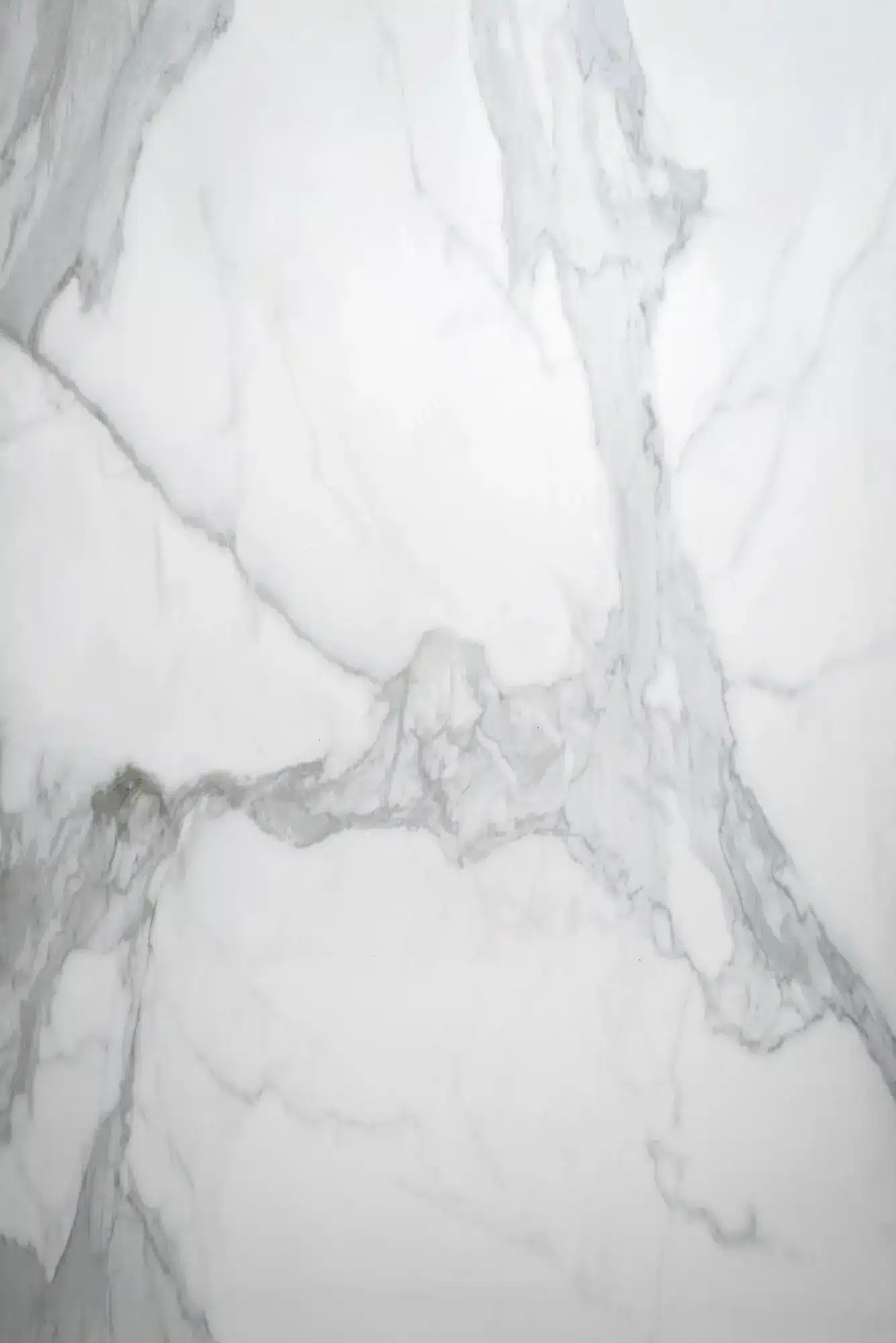 Porcelain Tile Flooring Denver featuring a luxurious white marble texture with elegant gray veining. The porcelain surface captures the timeless beauty of natural marble, offering a refined and durable option ideal for modern interiors, bathrooms, and kitchens with a sophisticated aesthetic.