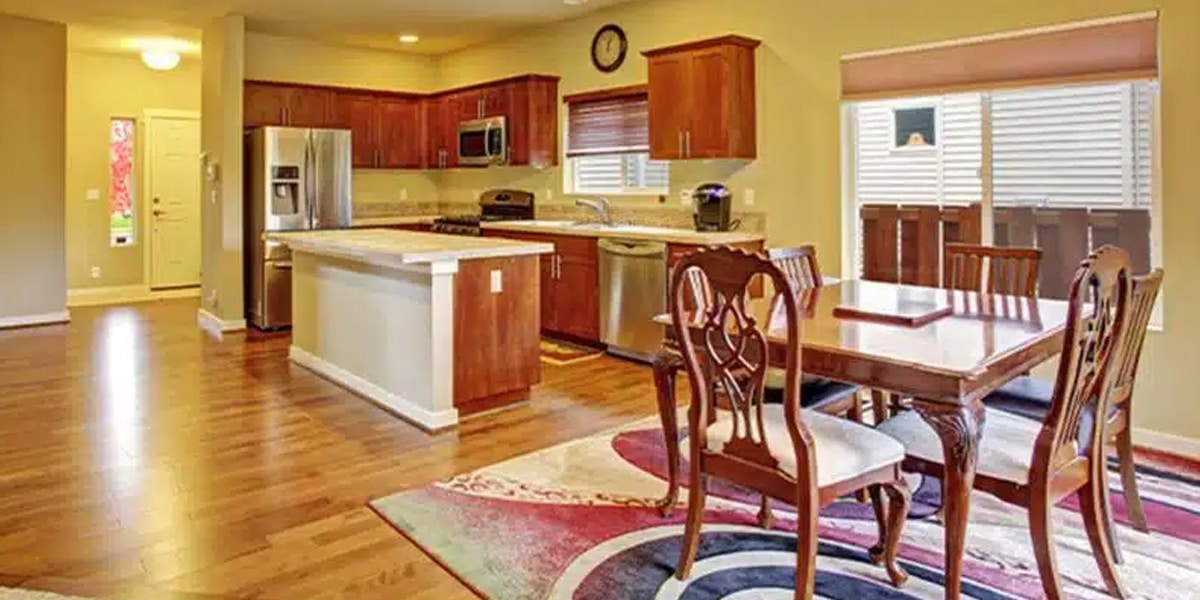 Spacious kitchen with sleek hardwood flooring in the dining area, expertly crafted by a flooring Denver expert for a refined and durable finish.