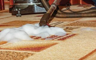 Vacuum cleaning foam on carpet, showing the process of how to remove water stains from the carpet for a fresh and clean appearance.