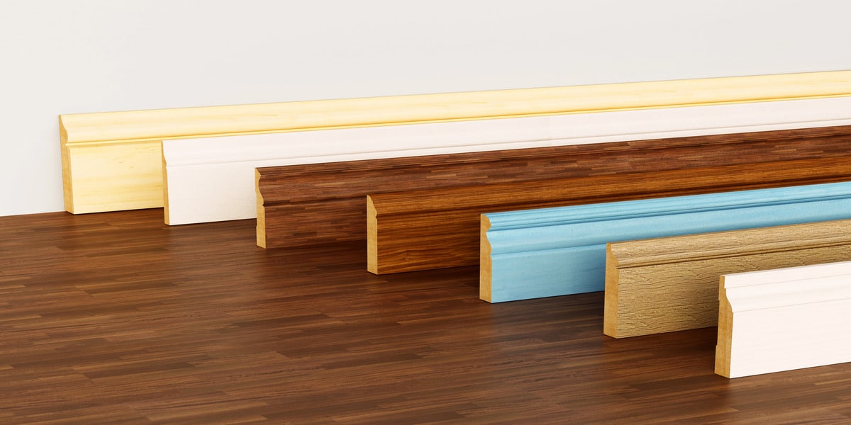 In Home Flooring explores Should Hardwood Floors Match Baseboards with a display of trim styles and colors to show matching and contrasting design choices.