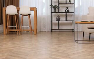 Modern living room with hardwood floor and furniture, exploring the pros and cons of luxury vinyl flooring as an alternative for style and durability.